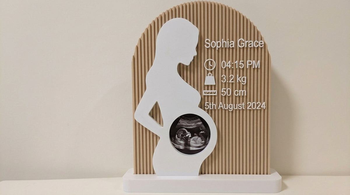 Close-up of a personalised pregnancy silhouette ultrasound frame with birth details