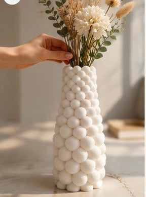 White bubble vase held in a hand in natural light