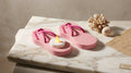Pink flip flop decor with tealight and dried flower arrangement