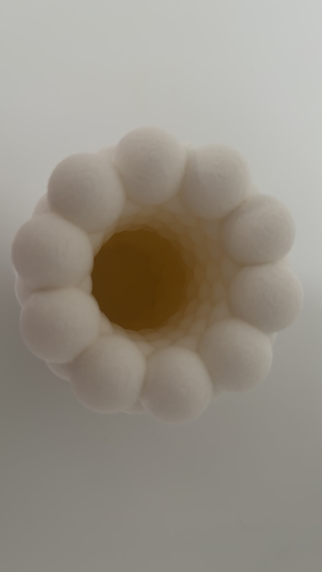 White bubble vase styled with flowers in a bright home